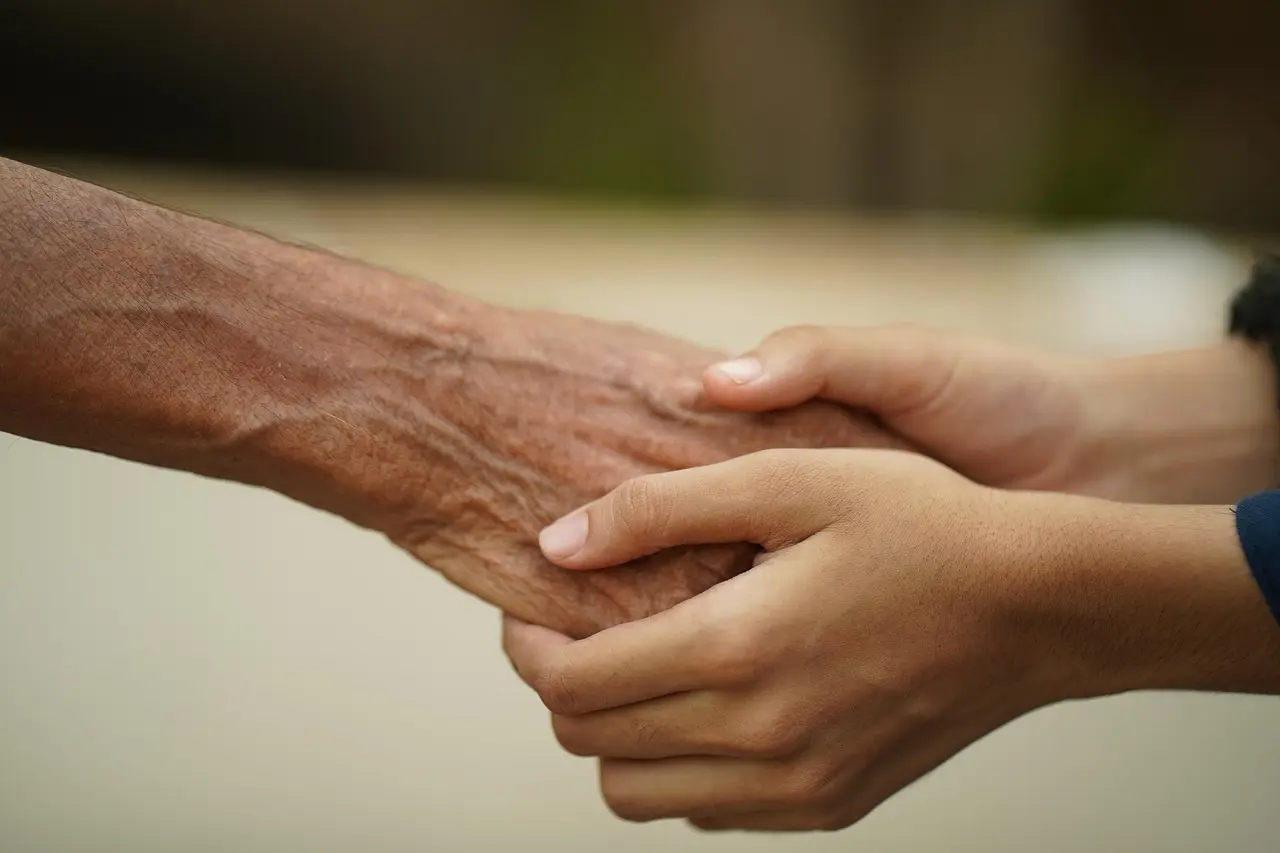 Hands offering comfort and support during PTSD recovery