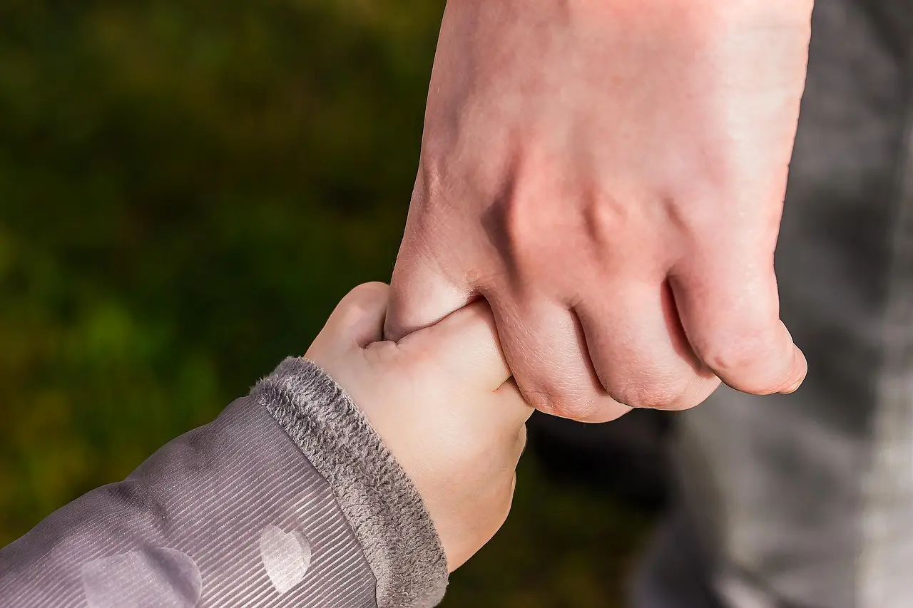 Hands held in a gesture of comfort and support