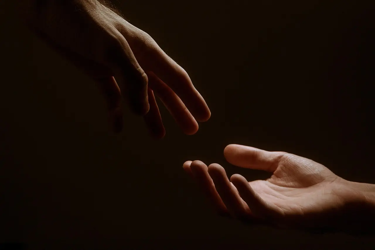 Hands held in a gesture of comfort and support