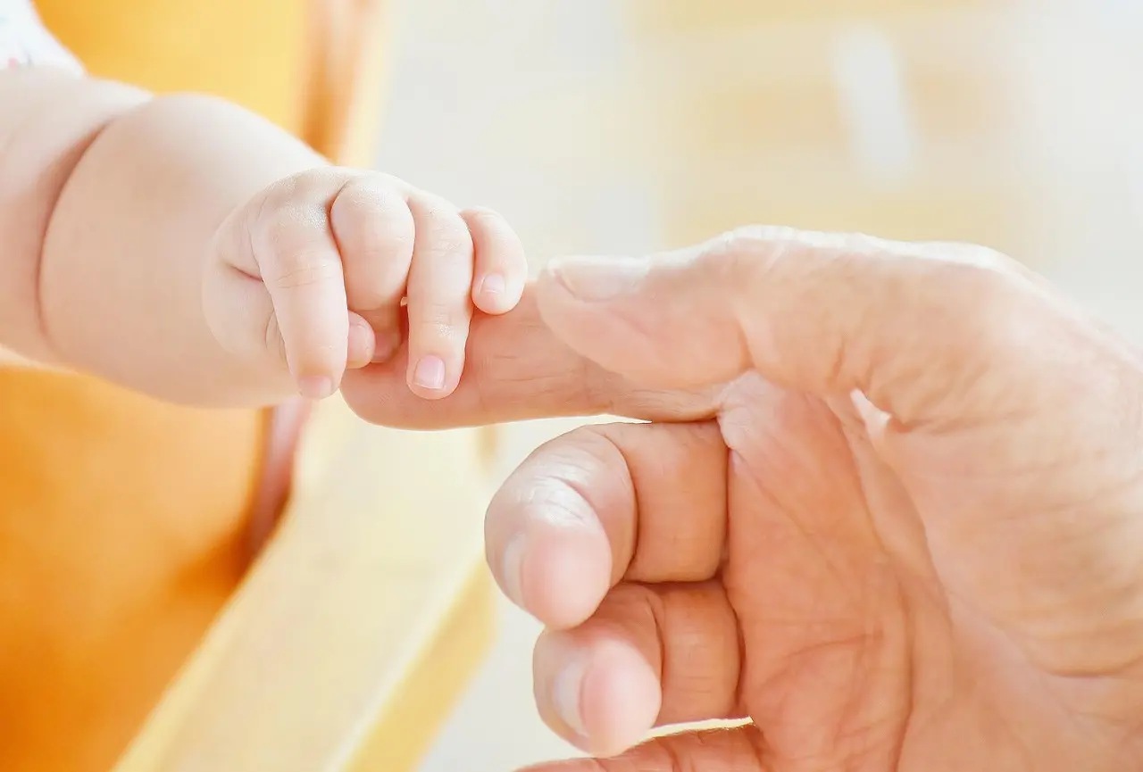 Hands held in a gesture of comfort and support