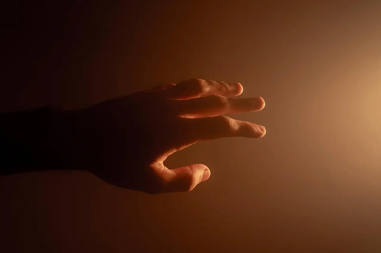 Hands held in a gesture of comfort and support