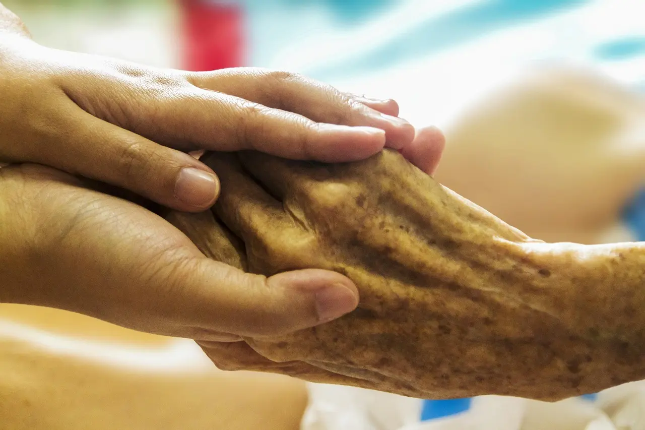 Hands held in a gesture of comfort and support