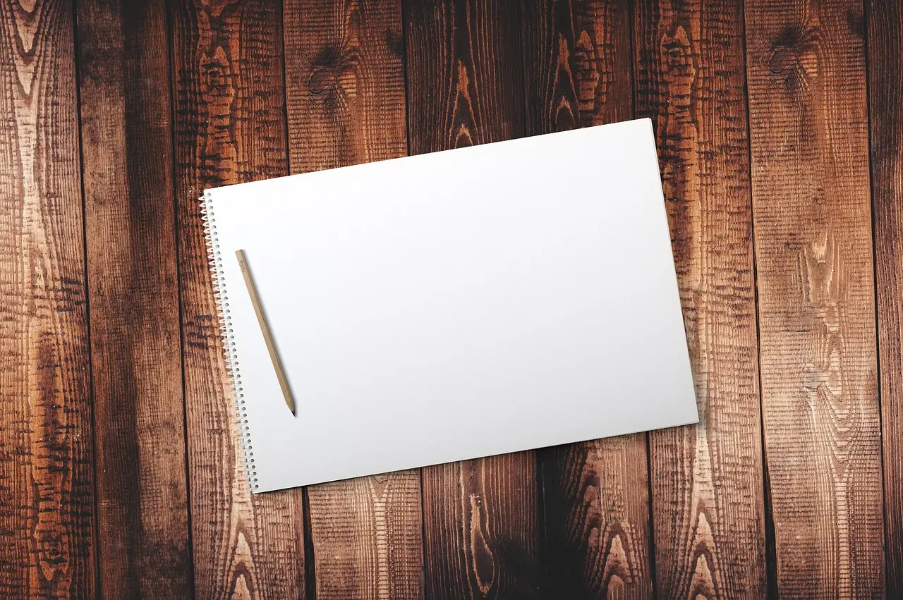 A patient taking notes while reviewing helpful mental health resources